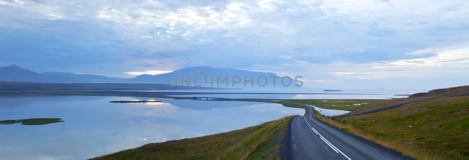 Highway through Iceland landscape at foggy day. Panorama