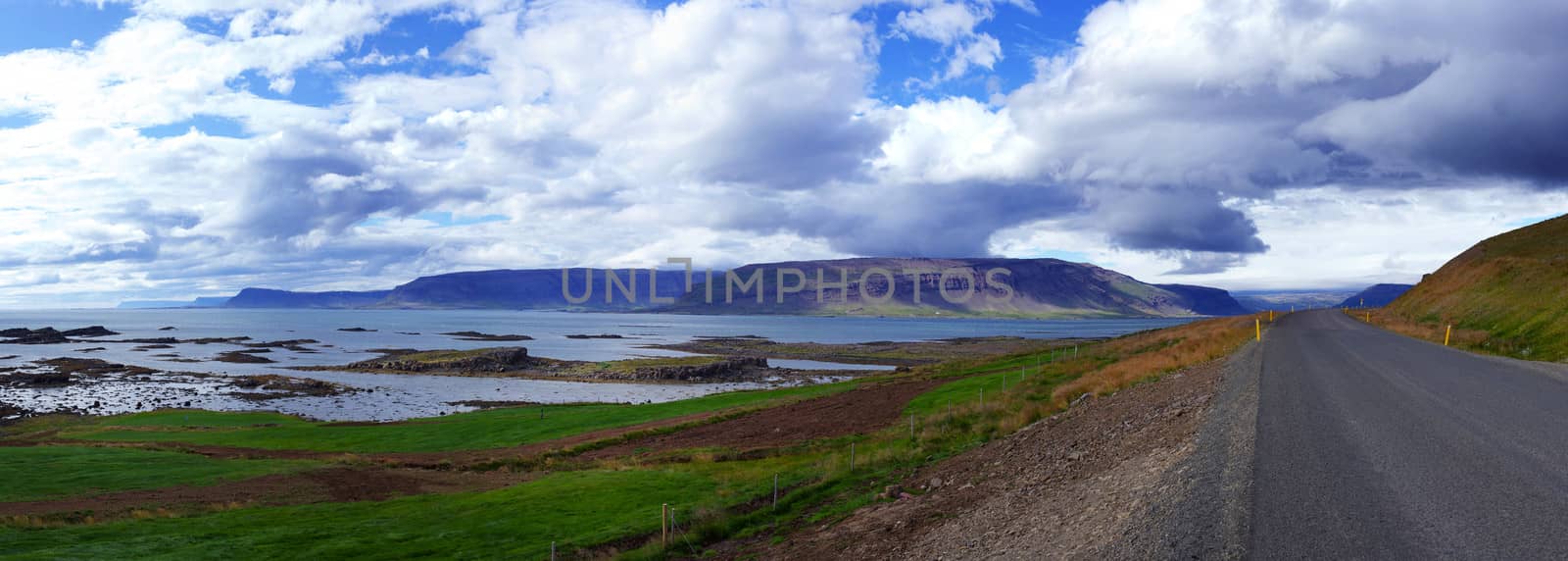 Highway through Iceland landscape at foggy day. Panorama