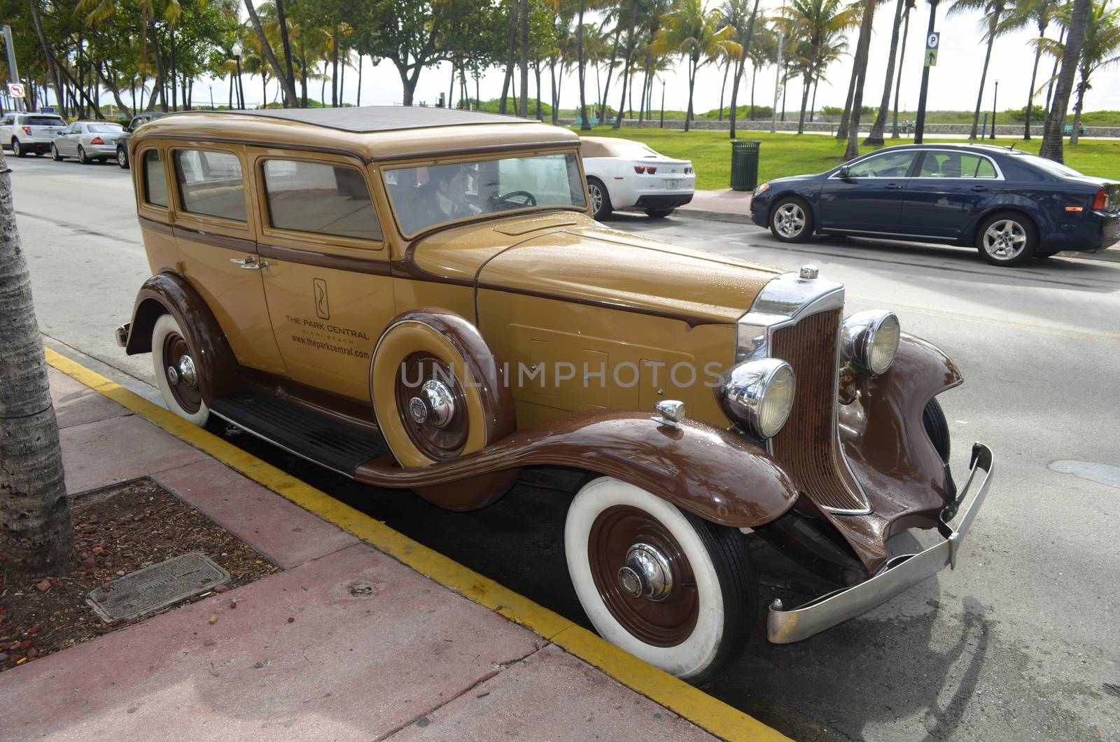 An antique Packard automobile being used to advertise a miami beach hotel parked on ocean drive in miami beach,florida