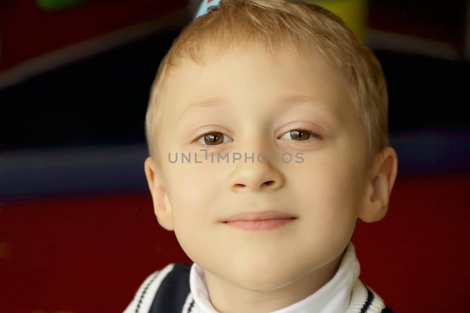 Portrait of sitting boy in white cloth