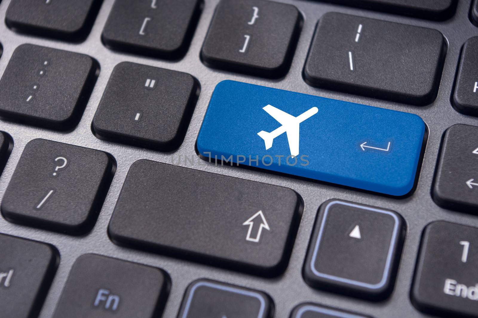 a plane sign on keyboard, to illustrate online booking or purchase of plane ticket or business travel concepts.