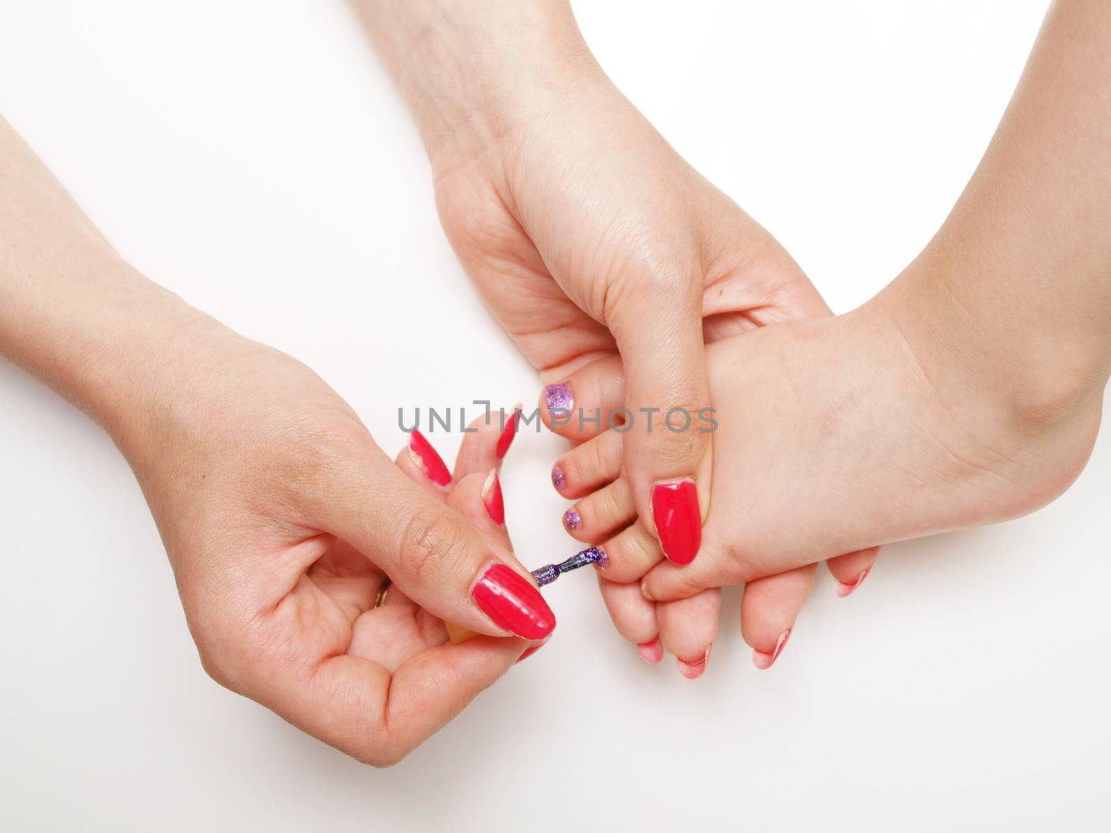 Child pedicure, purple sparkling nailpaint, isolated towards white