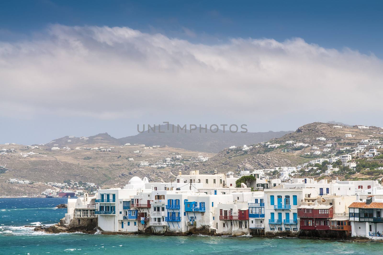 White houses of island Mykonos from the mountains to the sea in sunny weather