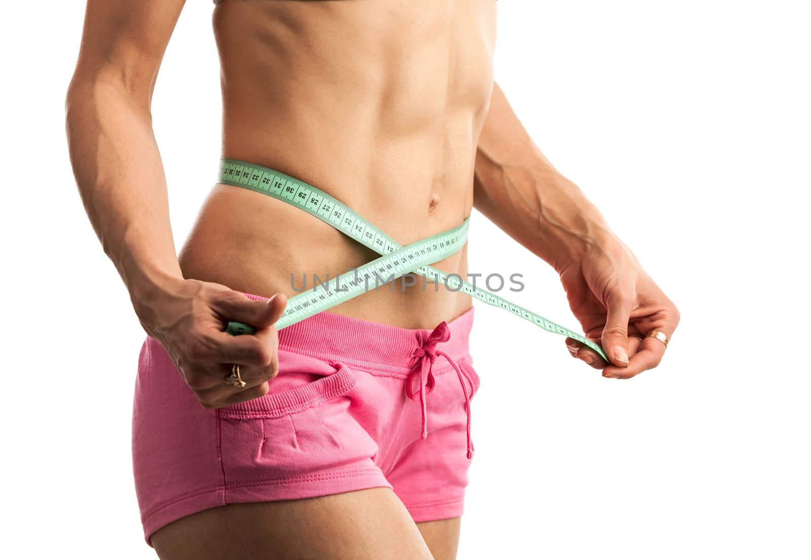 Cropped view of young fitness woman with measuring tape