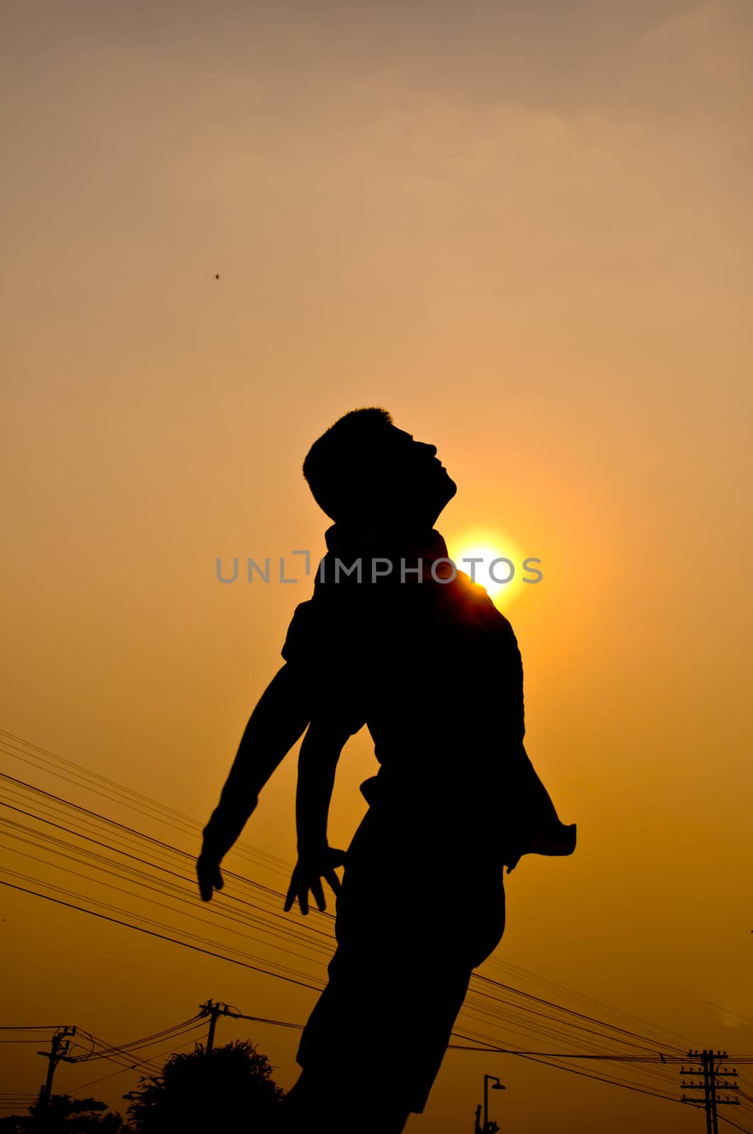 silhouette of boy feel free and happy