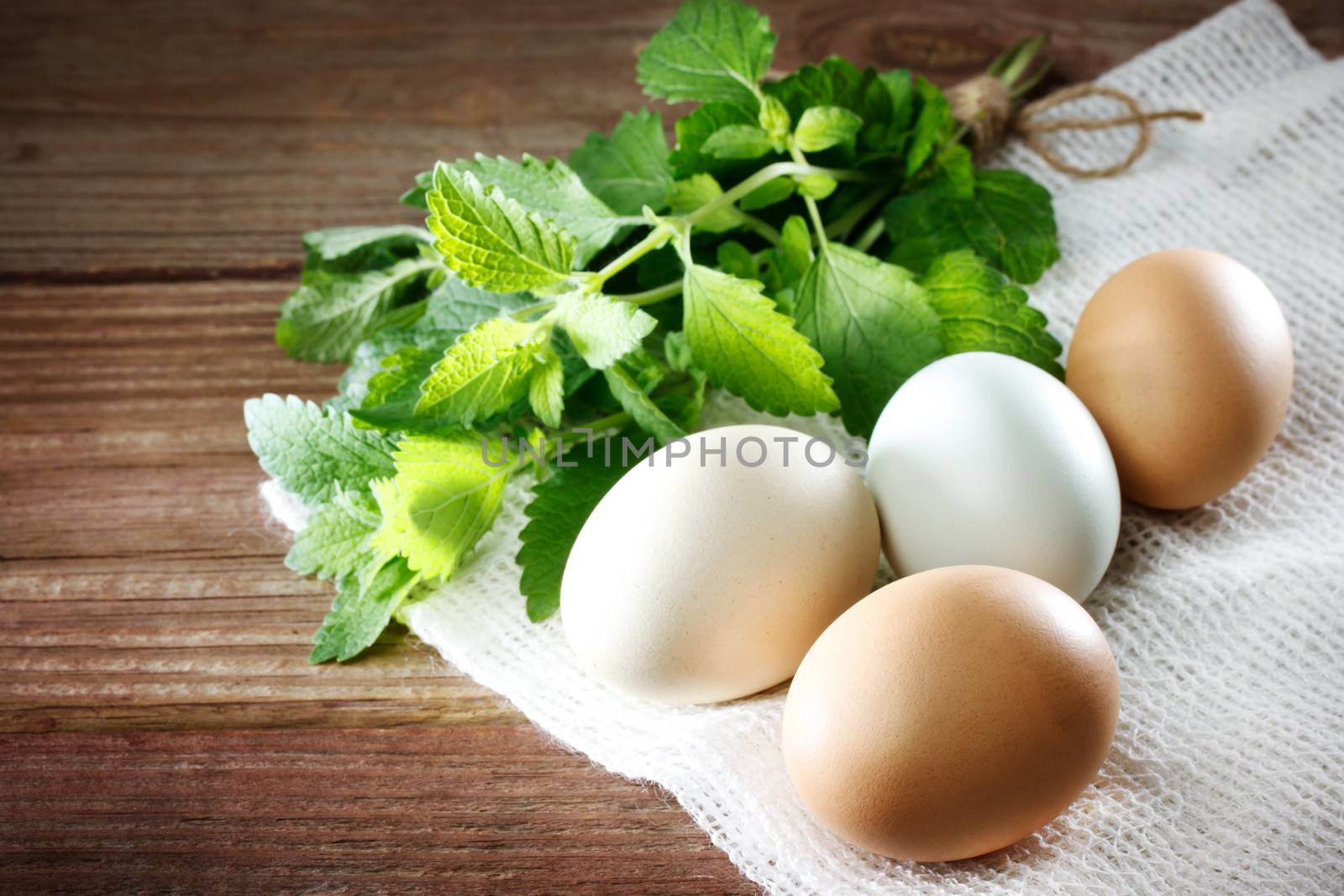 Eggs on a rustic wooden table  by melpomene