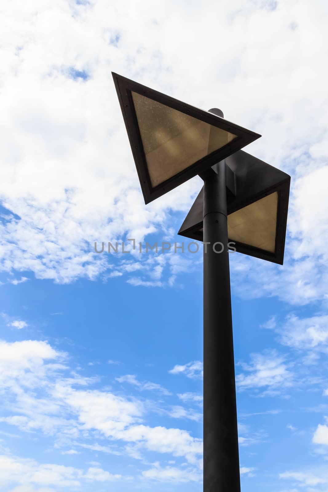 Triangle-shaped Street Lamp against White Cloud and Blue Sky by punpleng
