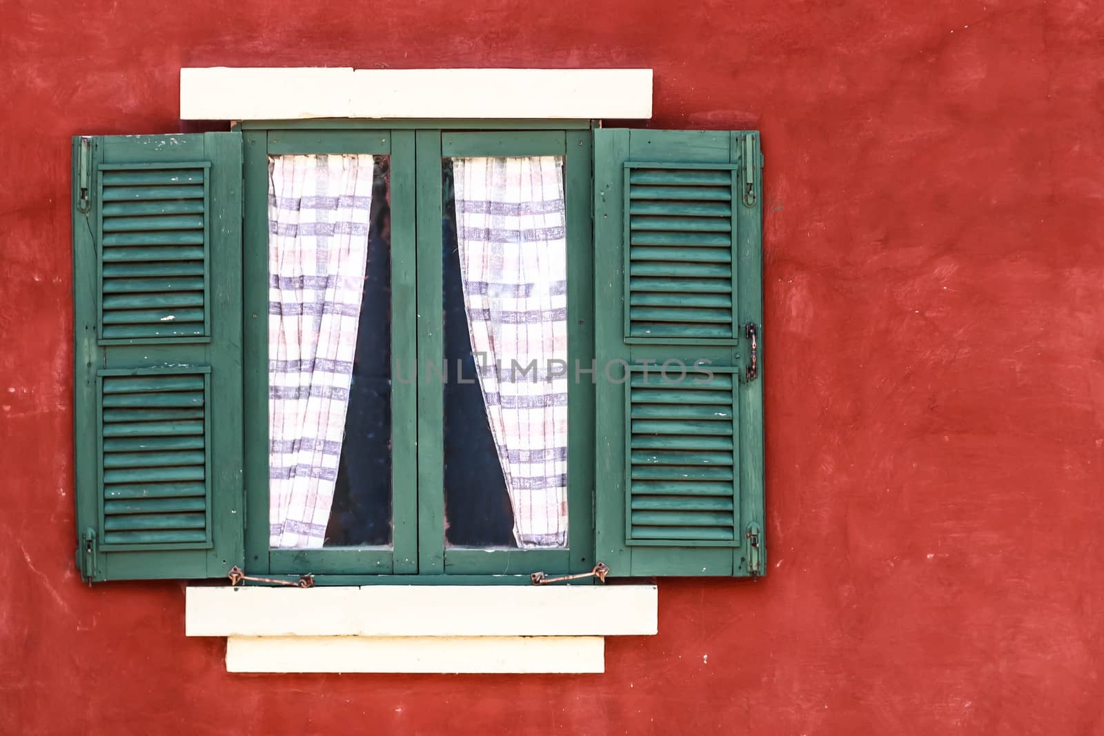 Old Green Window with Curtain on Red Wall,  Copy Space on Right