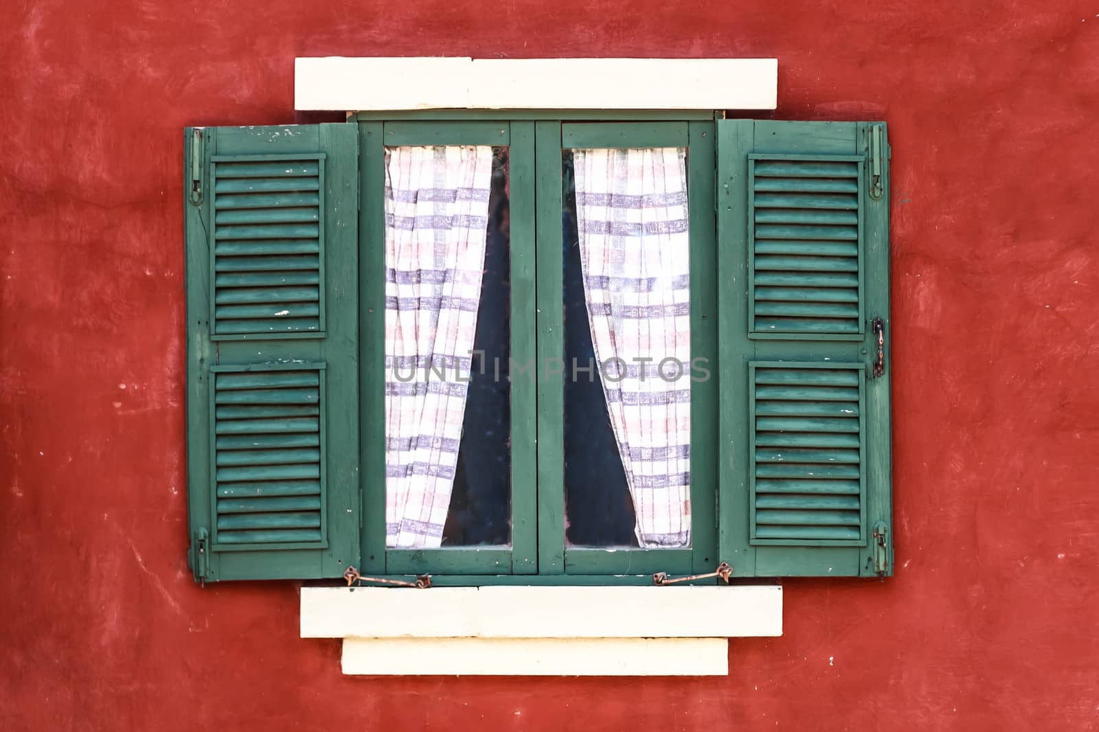 Old Green Window with Curtain on Red Wall