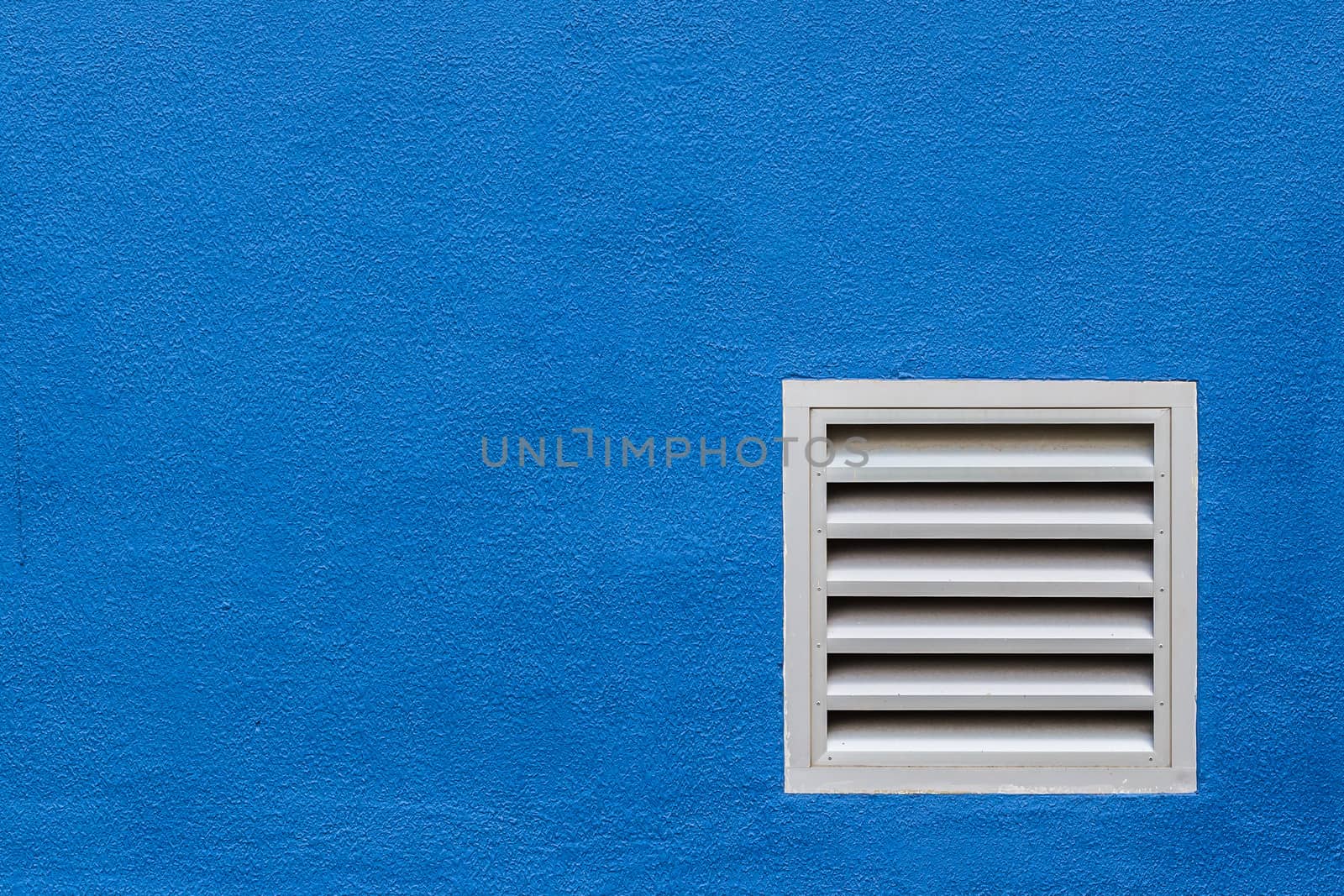 White Vent on Blue Concrete Wall by punpleng