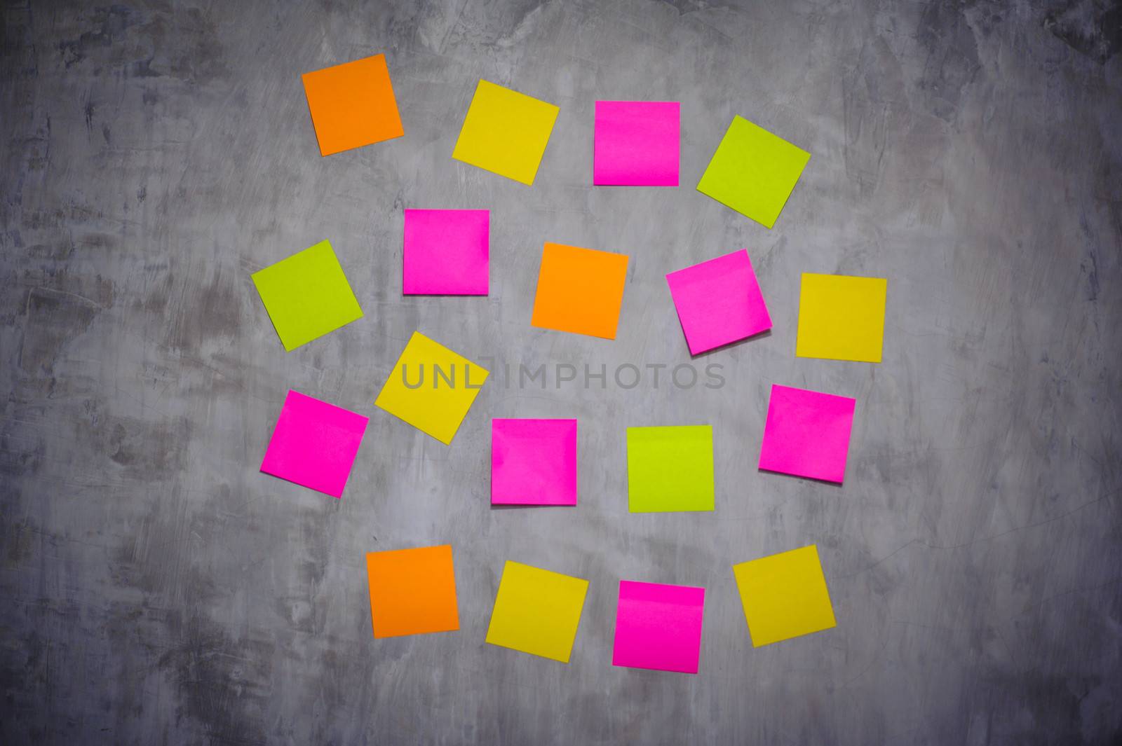 Bright Post-it Notes on grey wall