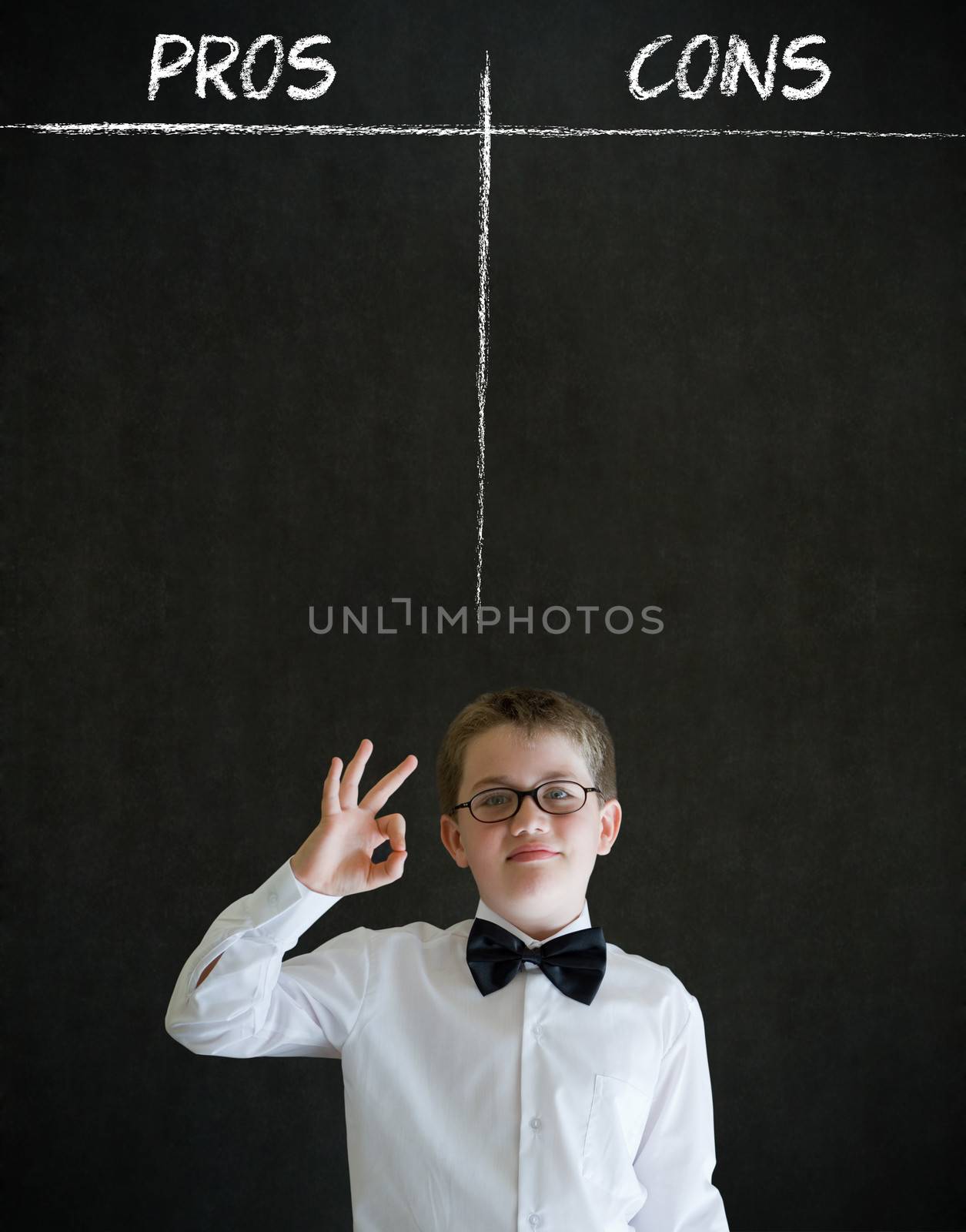 All ok or okay sign boy dressed up as business man with chalk pros and cons decision list on blackboard background