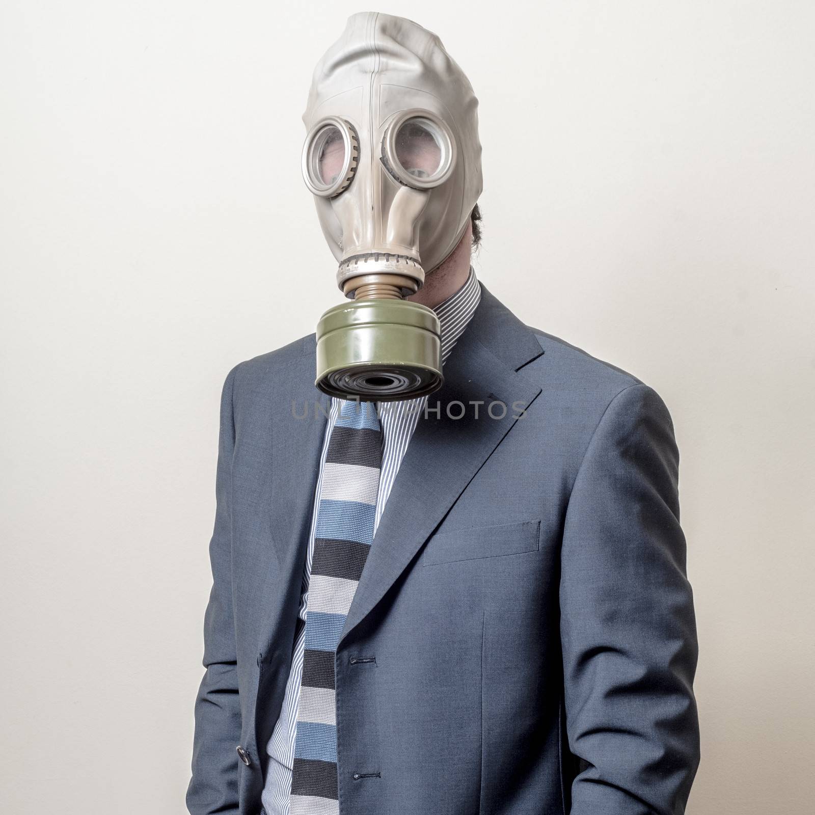 businessman with gas mask on gray background