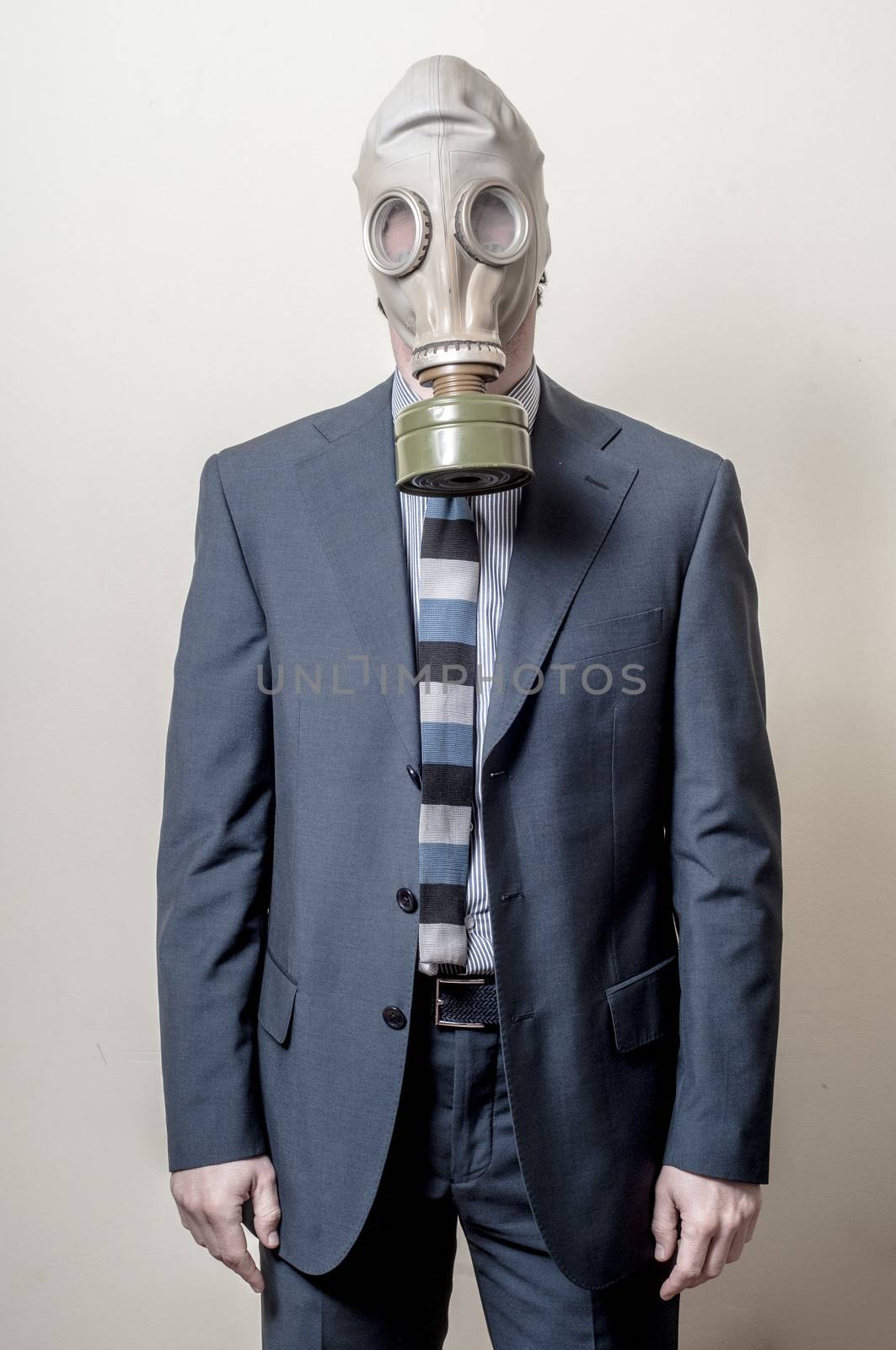 businessman with gas mask on gray background