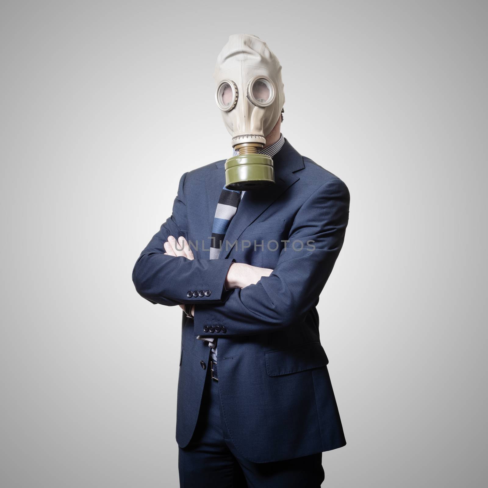 businessman with gas mask on gray background