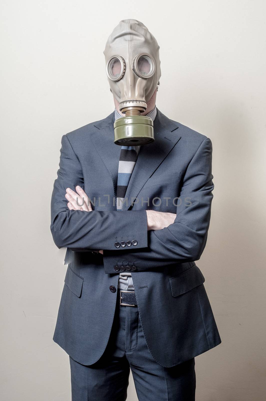 businessman with gas mask on gray background