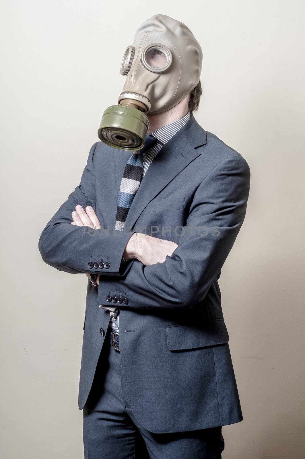 businessman with gas mask on gray background