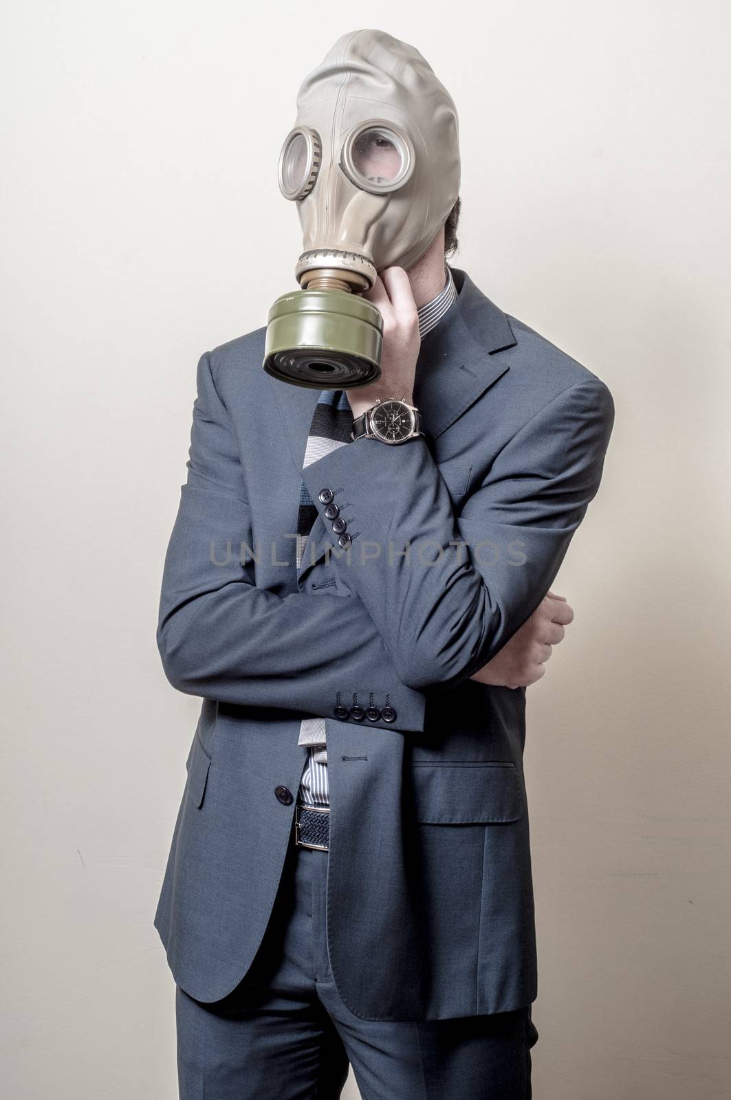 businessman with gas mask on gray background