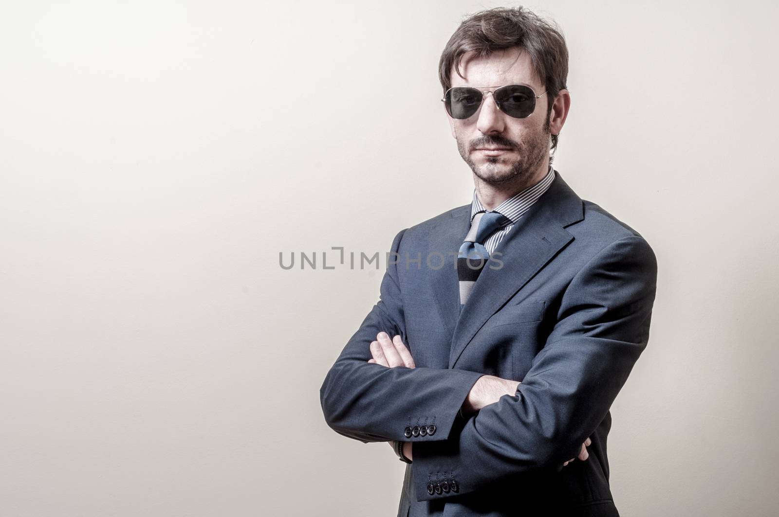 businessman serious with sunglasses on gray background