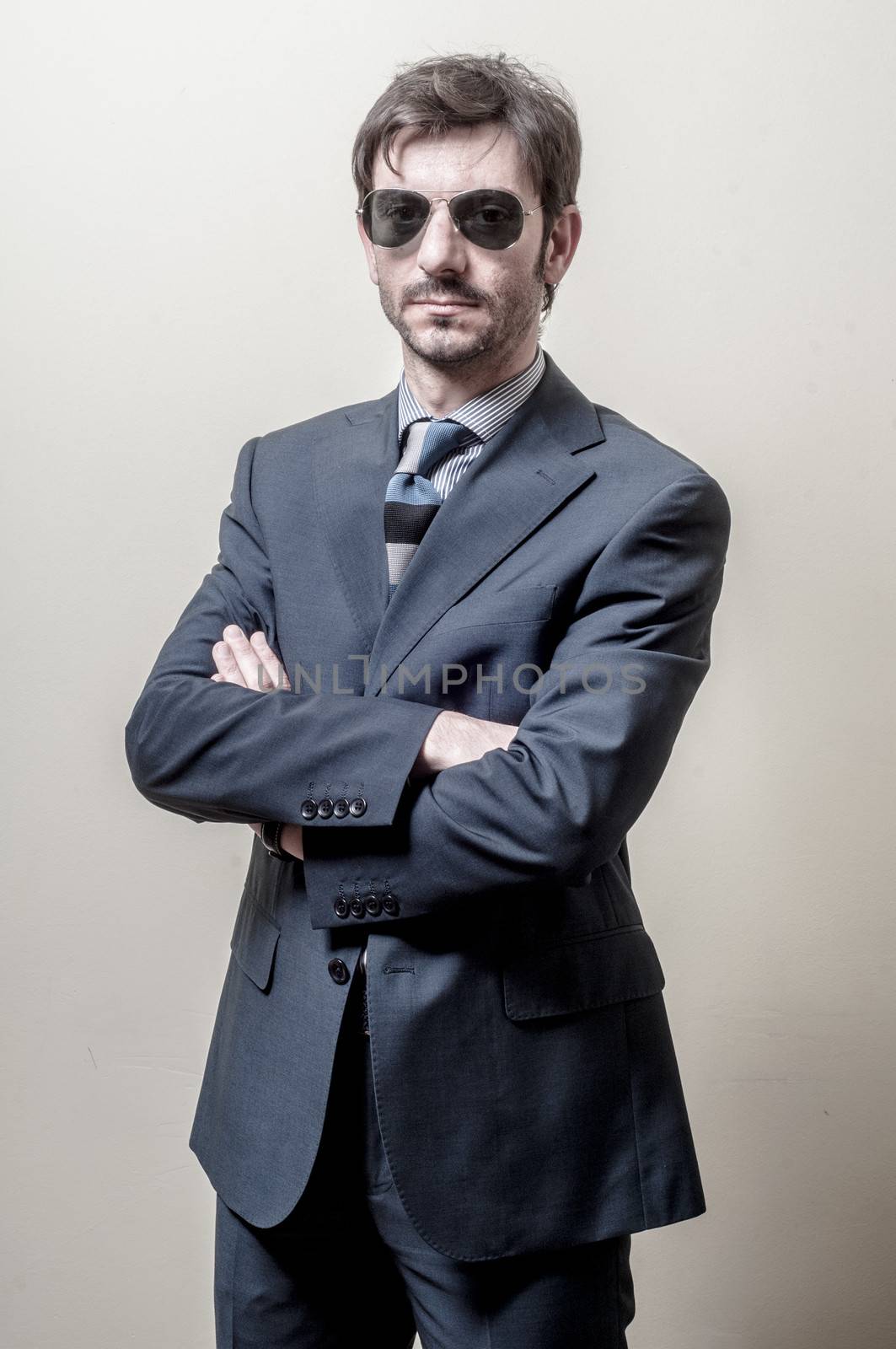 businessman serious with sunglasses on gray background