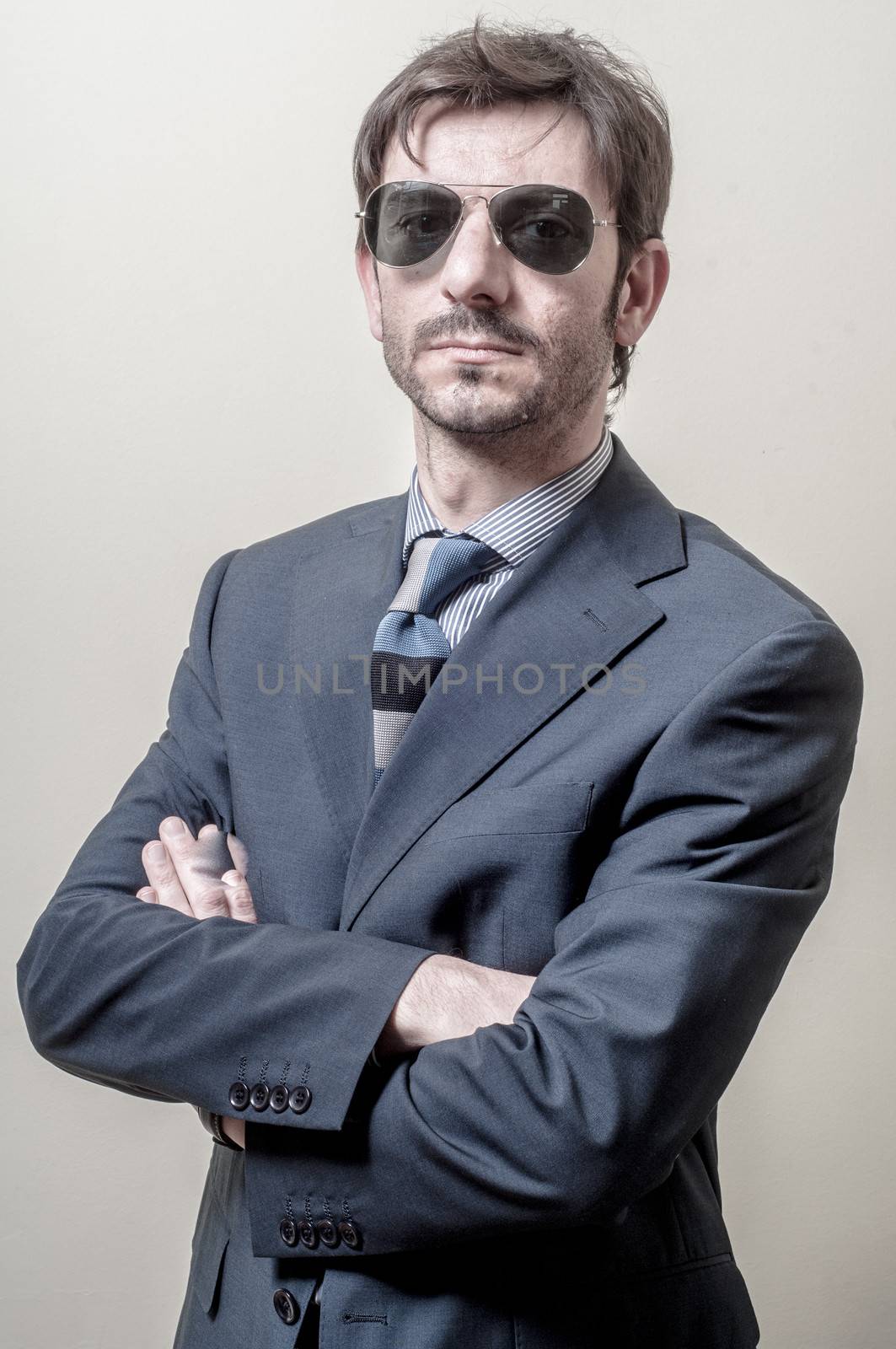 businessman serious with sunglasses on gray background
