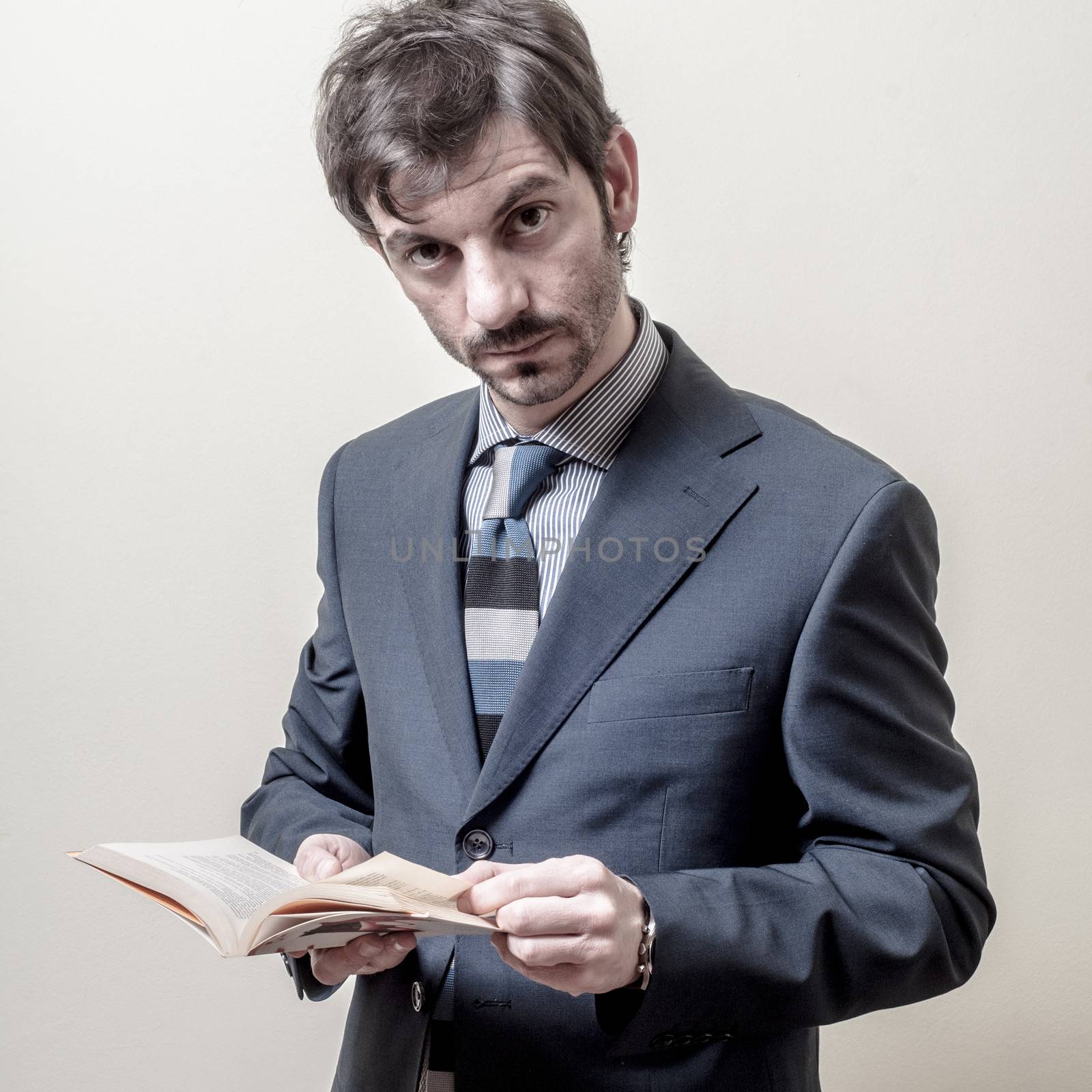 businessman reading book on gray background