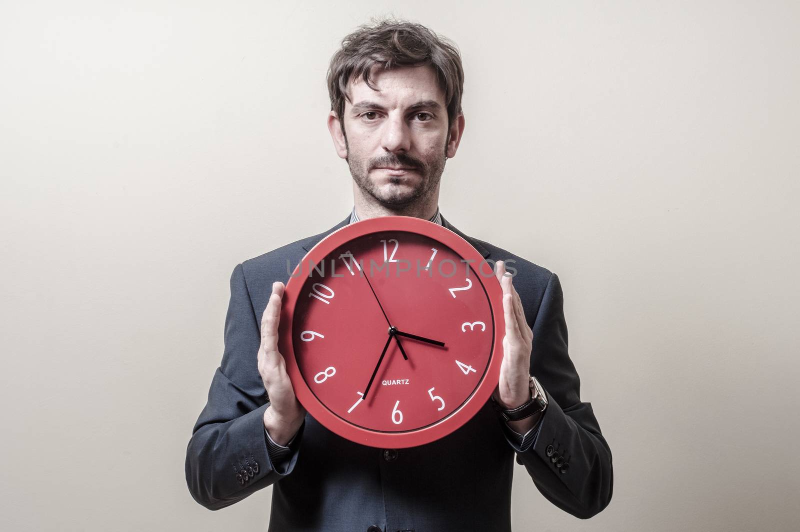 businessman with clock on gray background