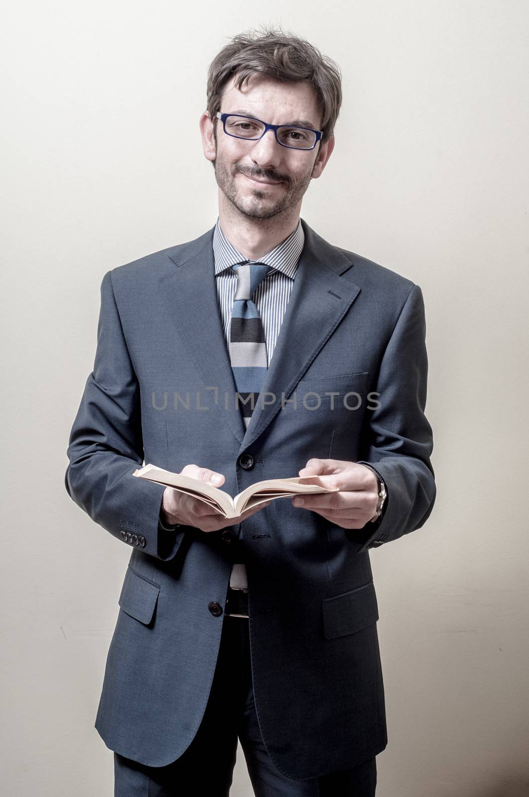 businessman reading book on gray background