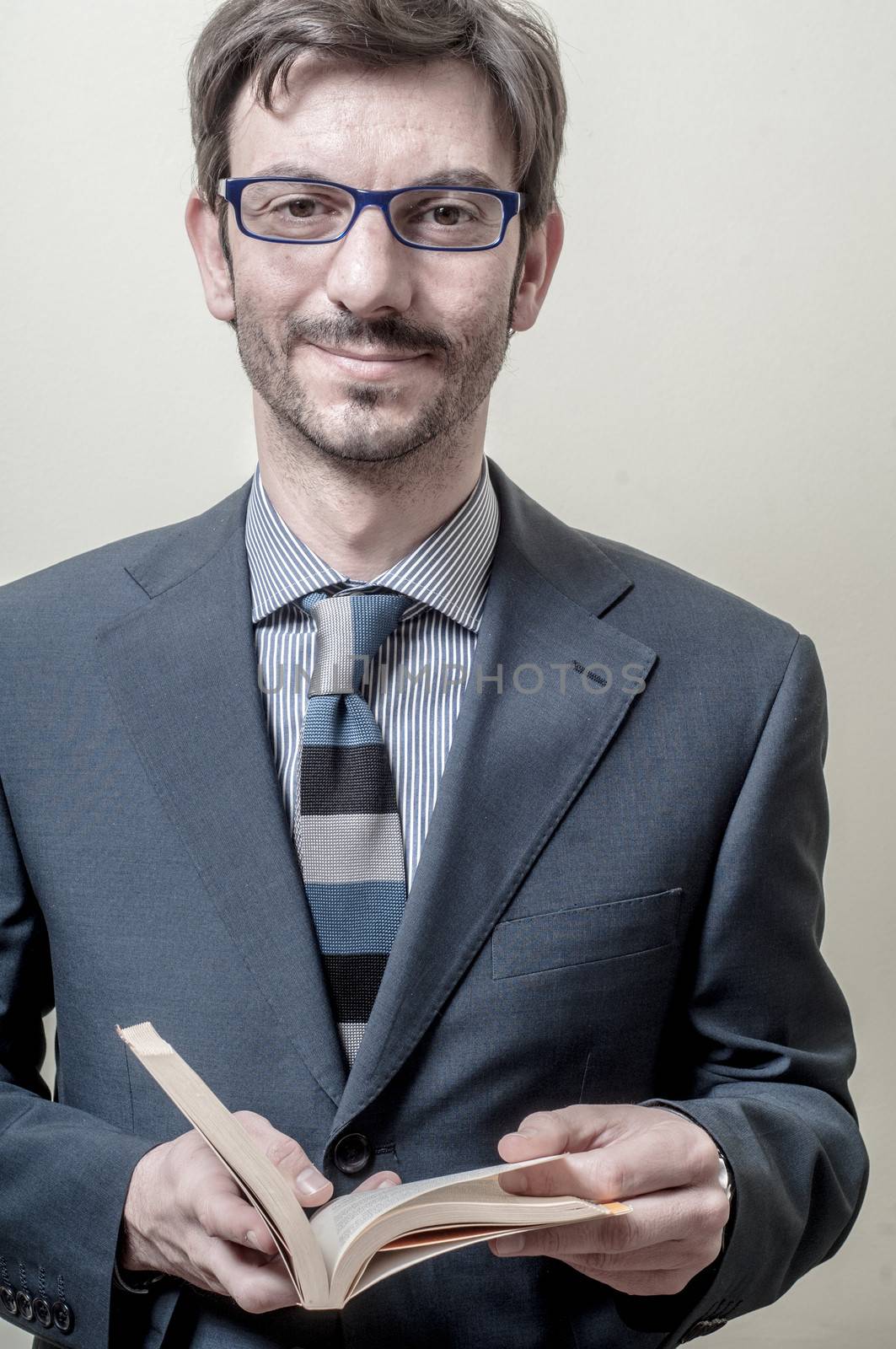 businessman reading book on gray background