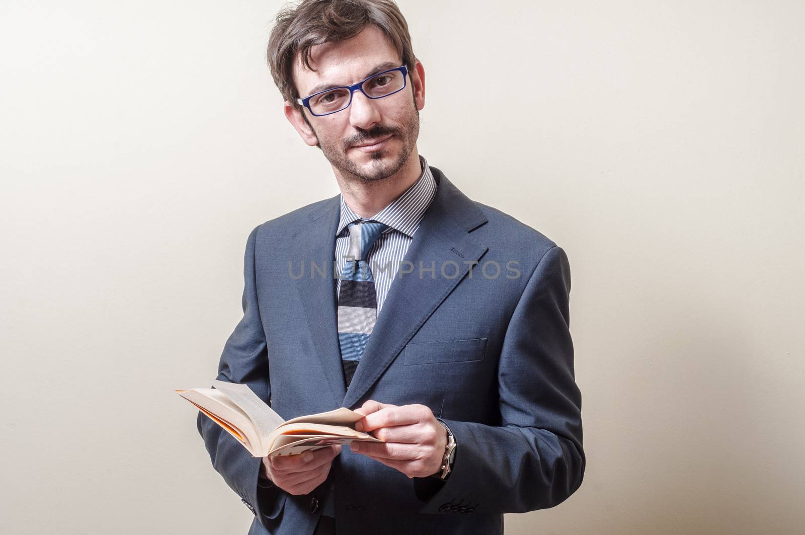 businessman reading book on gray background