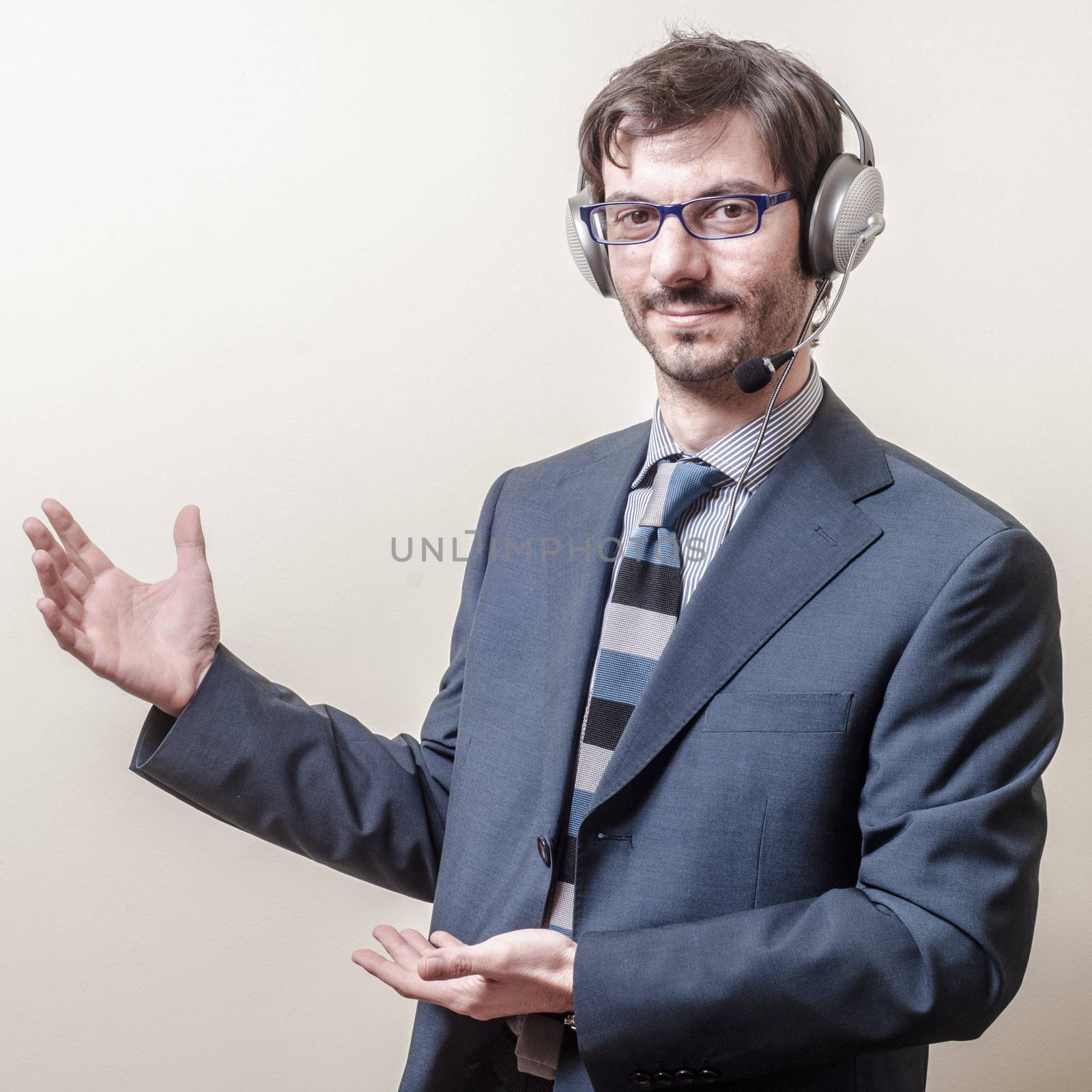 businessman with headphone and microphone on gray background