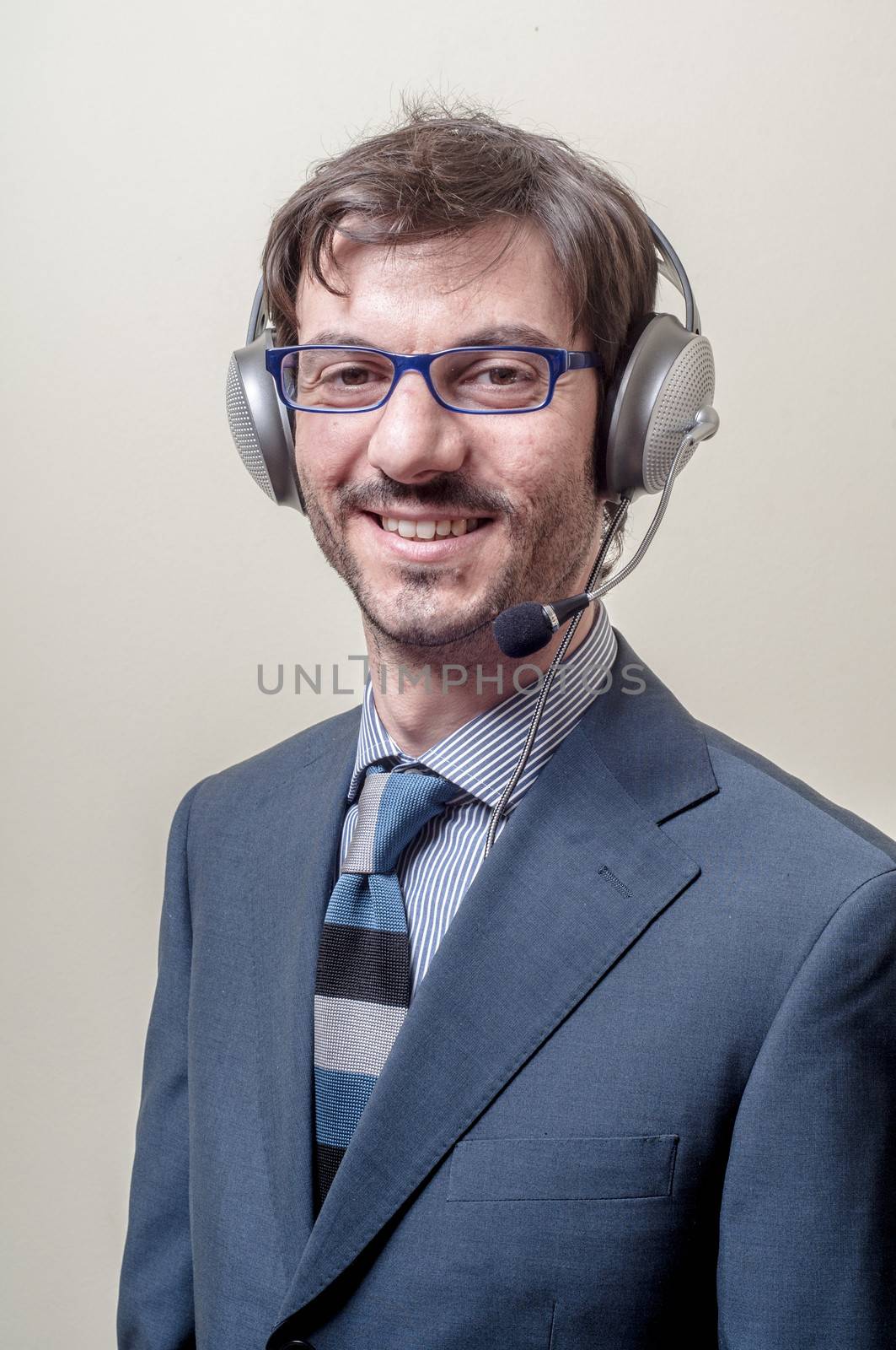 businessman with headphone and microphone on gray background
