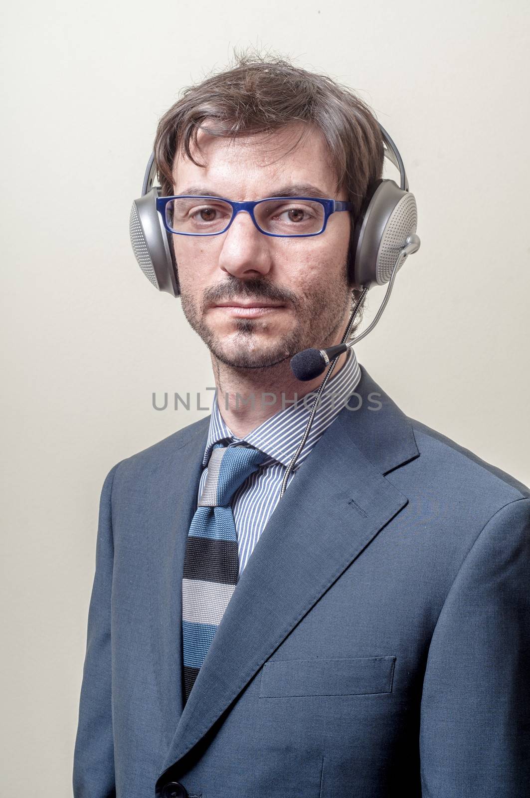 businessman with headphone and microphone on gray background