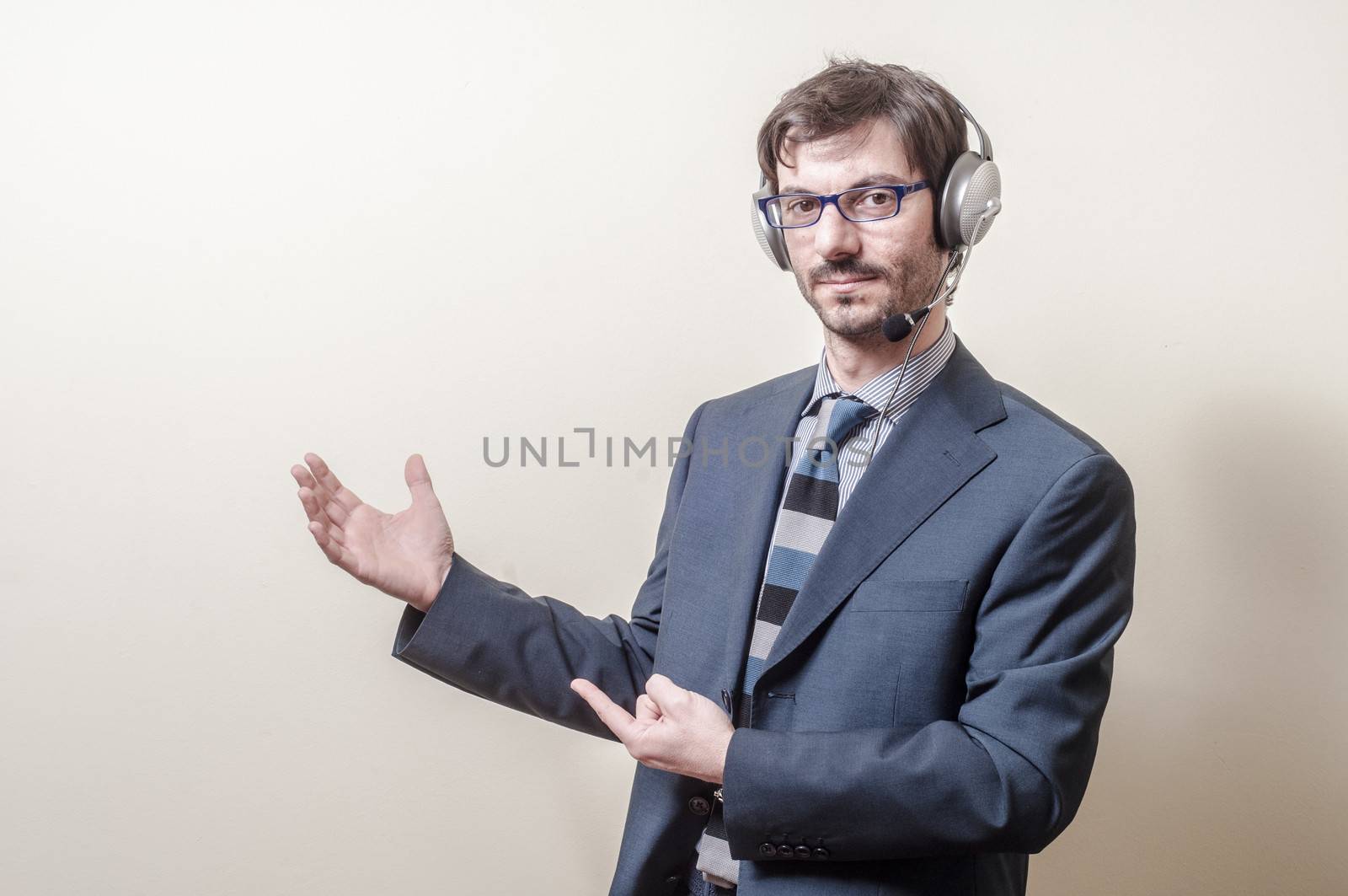 businessman with headphone and microphone on gray background