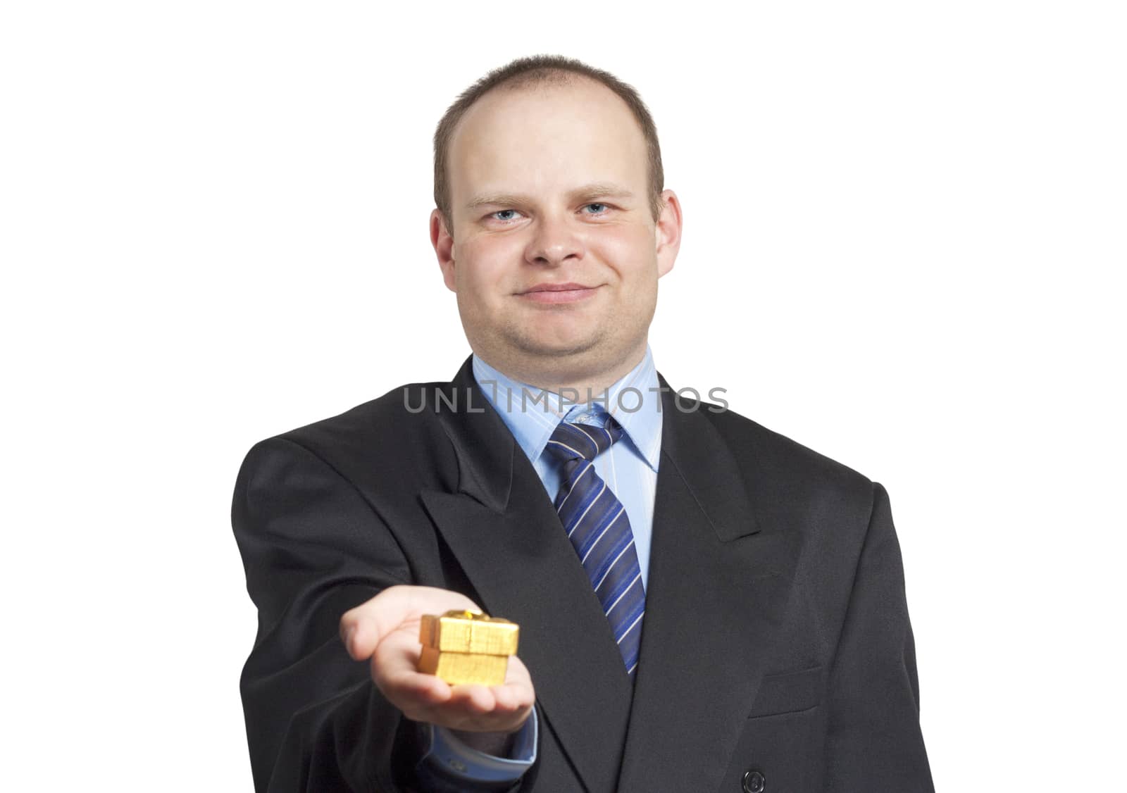 Young man in a suit giving a gift isolated