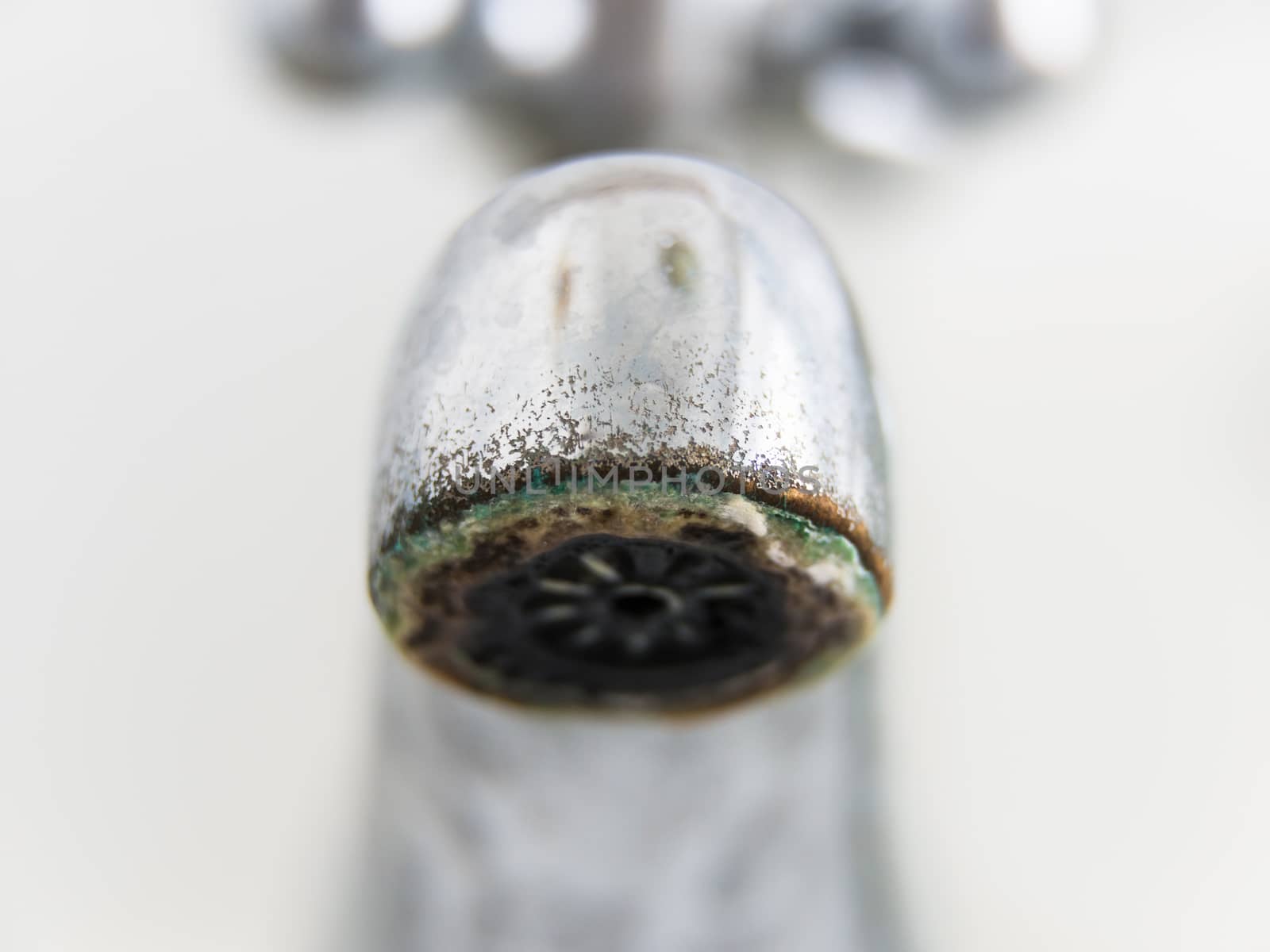 Old and grungy tap closeup, white background