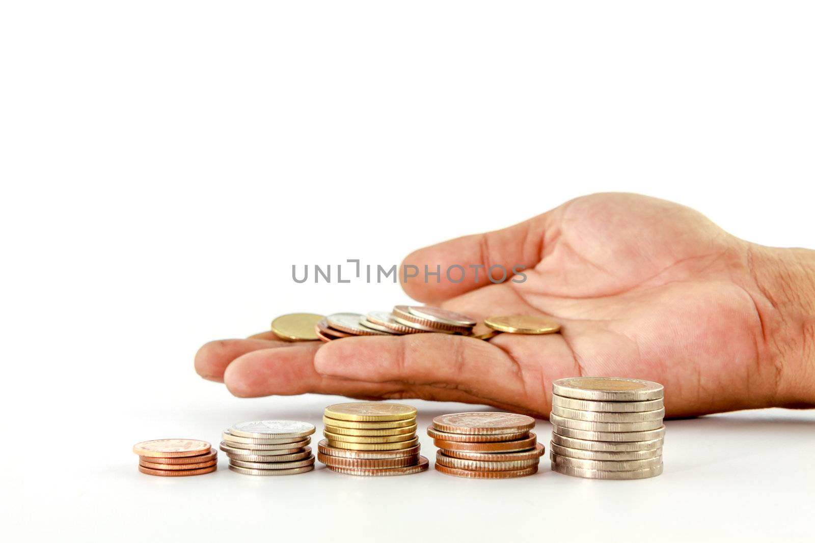 Stack of coins in hand  on white background