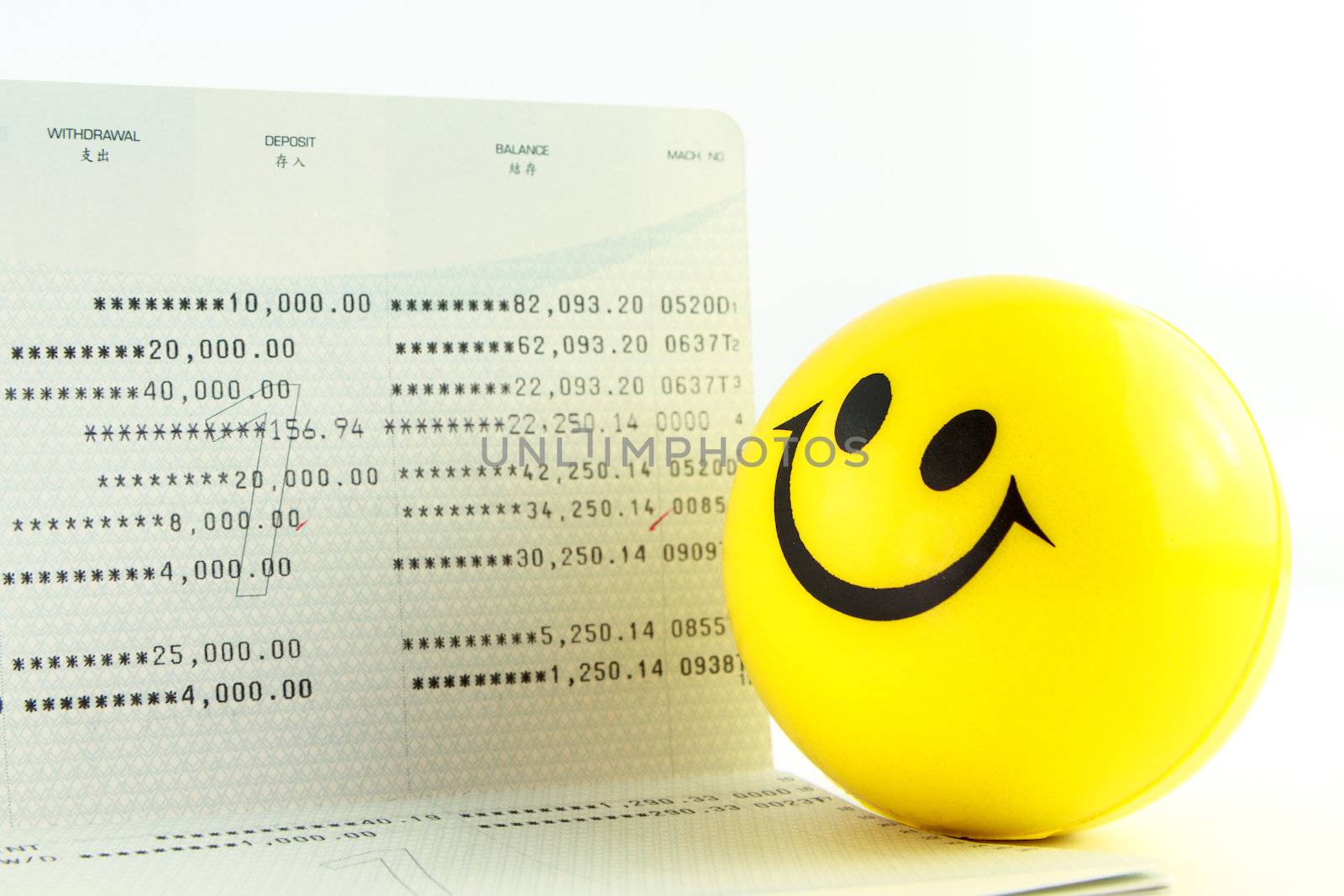 Smile ball and account passbook on white background