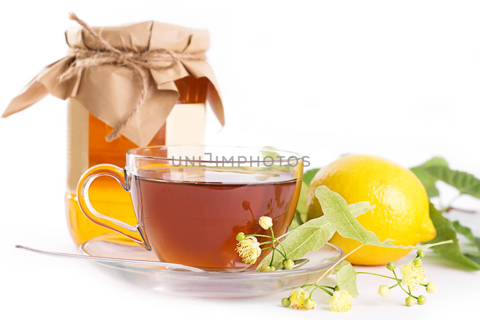 Lemon tea with linden honey jar and flowers by Angel_a