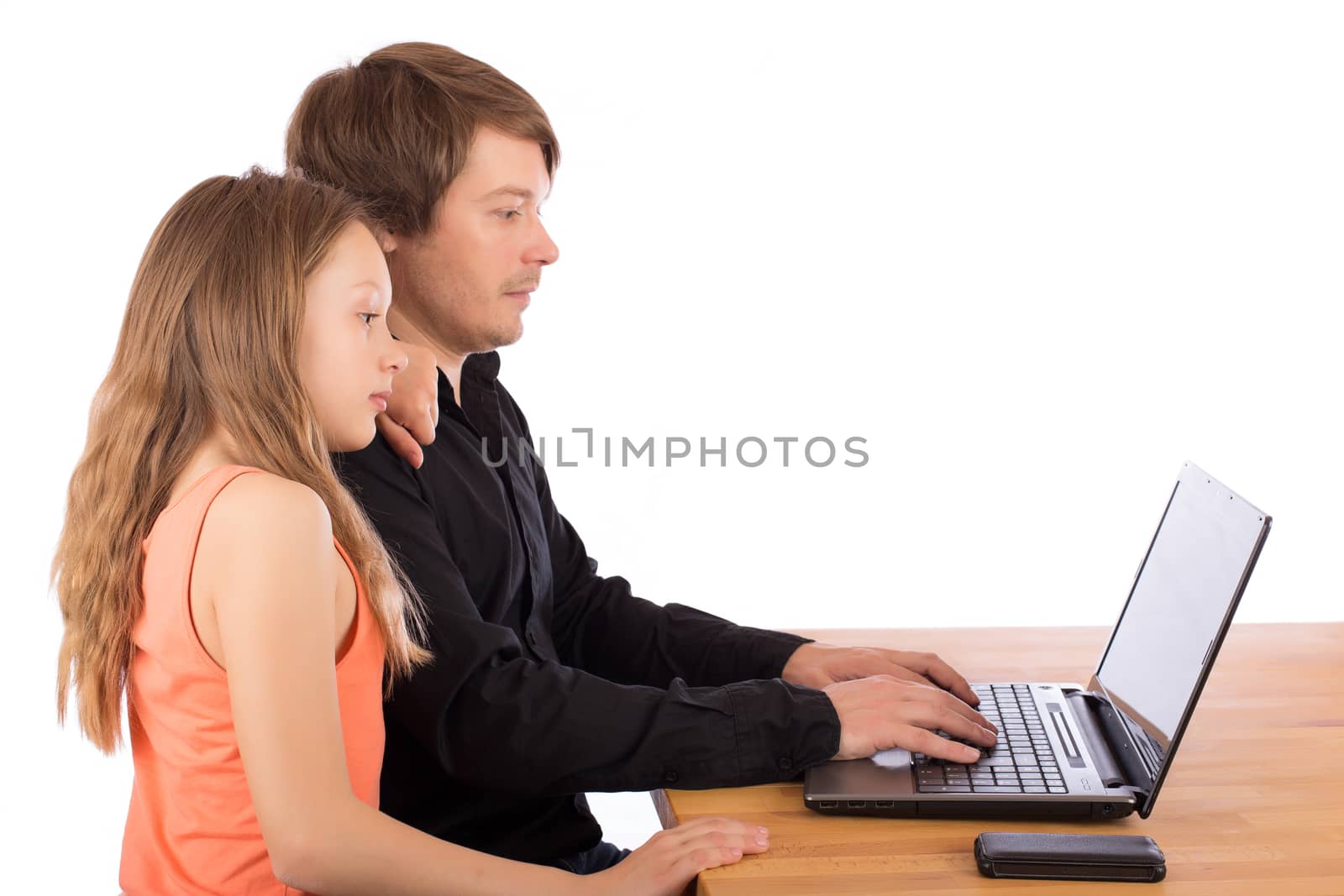 Father working with his daughter on a laptop. Isolated on a white background.