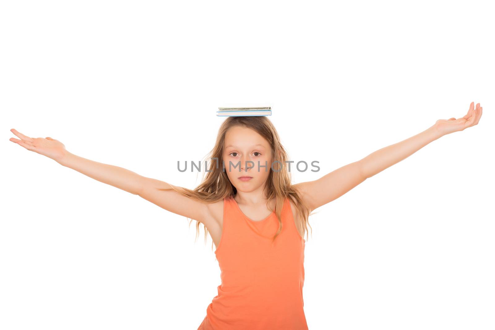 Child with a book on her head. Isolated on a white background.