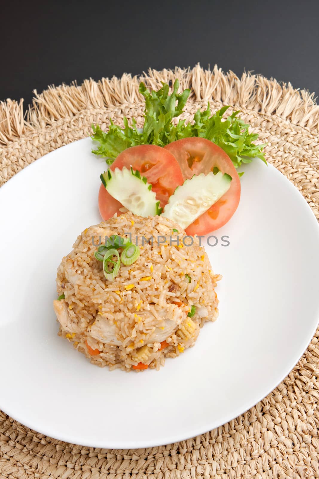 A Thai dish of crab fried rice presented on a square white plate.