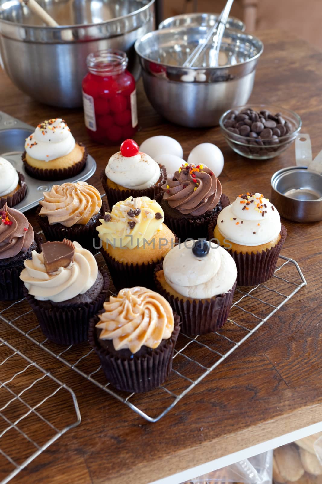 Close up of some decadent gourmet cupcakes frosted with a variety of frosting flavors.