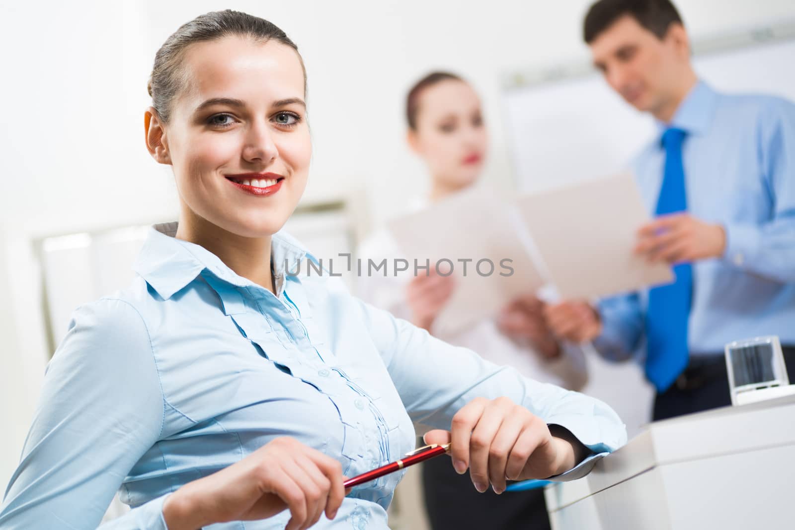 portrait of a business woman in office, smiling and looking into the camera, office work