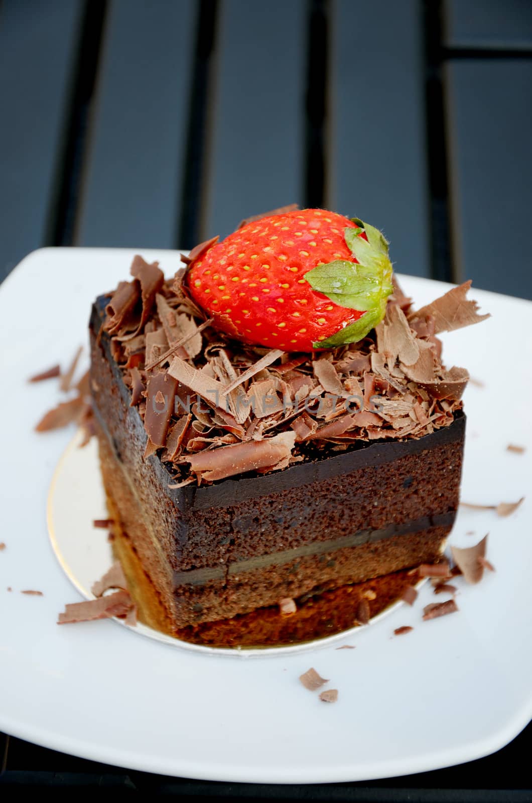 Chocolate cake with strawberry on the white plate