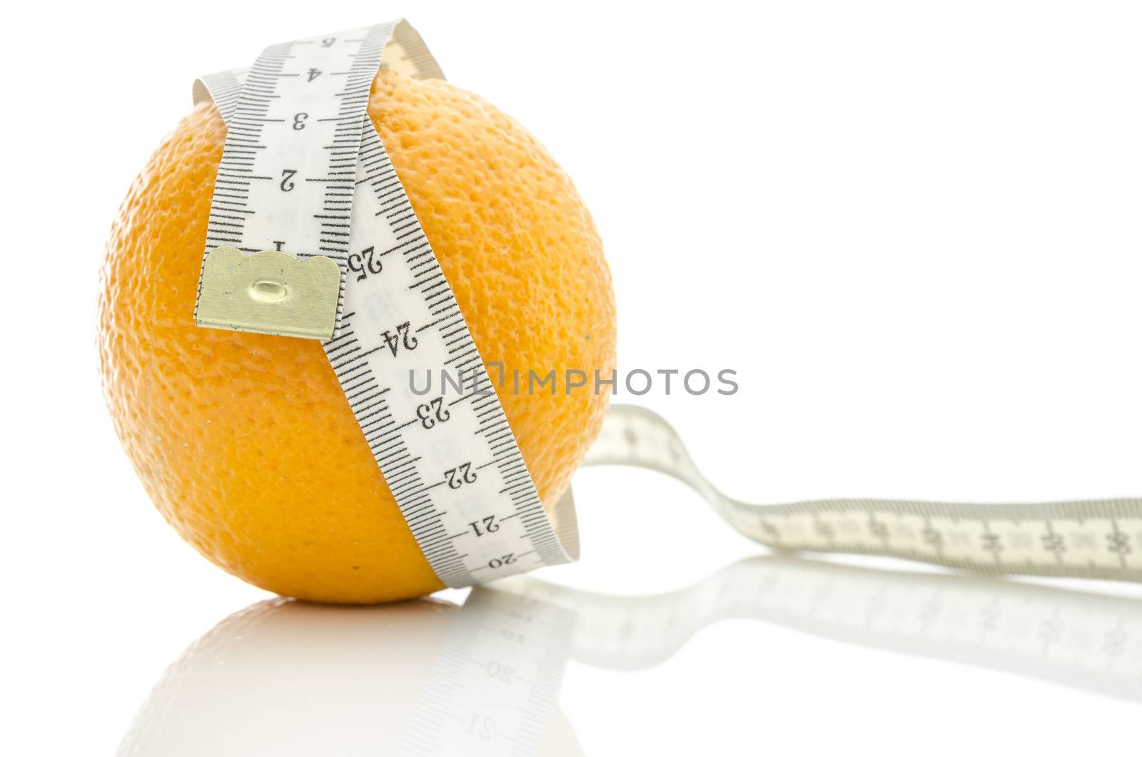 Fresh orange wrapped with measuring tape. Concept of dieting and body care.