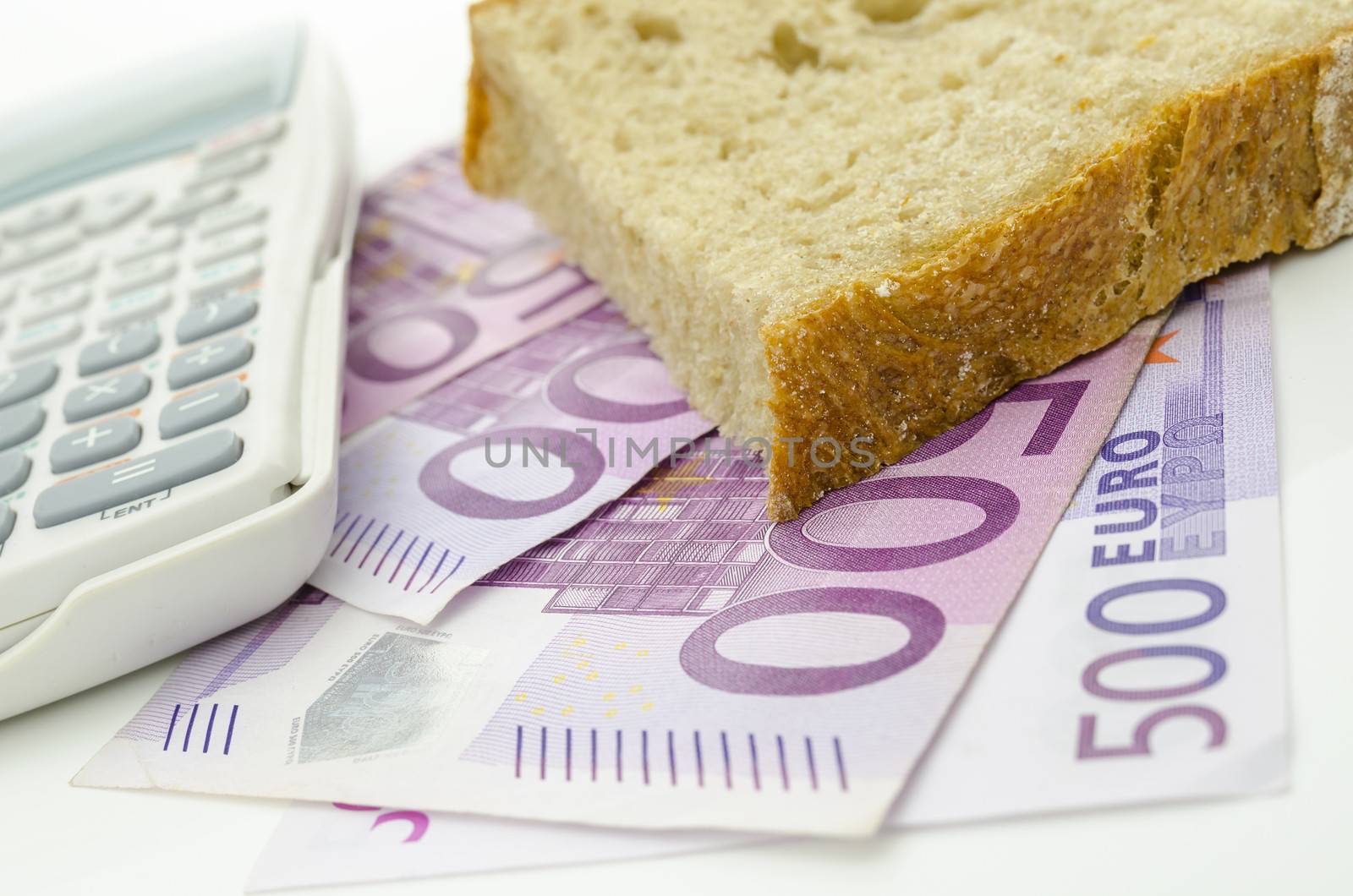 Piece of bread on Euro money. Food budget.