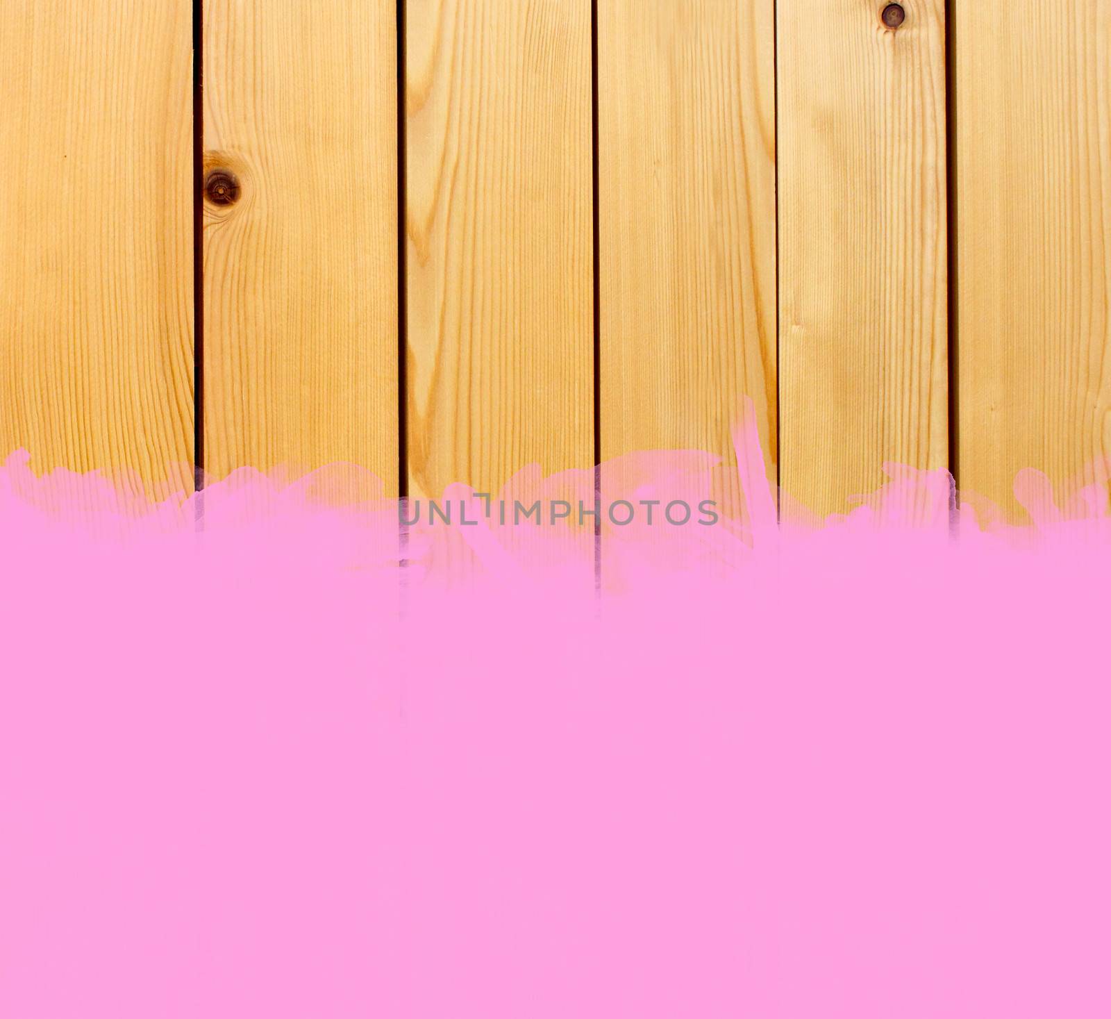 Pink stroke of the paint brush on wooden background 