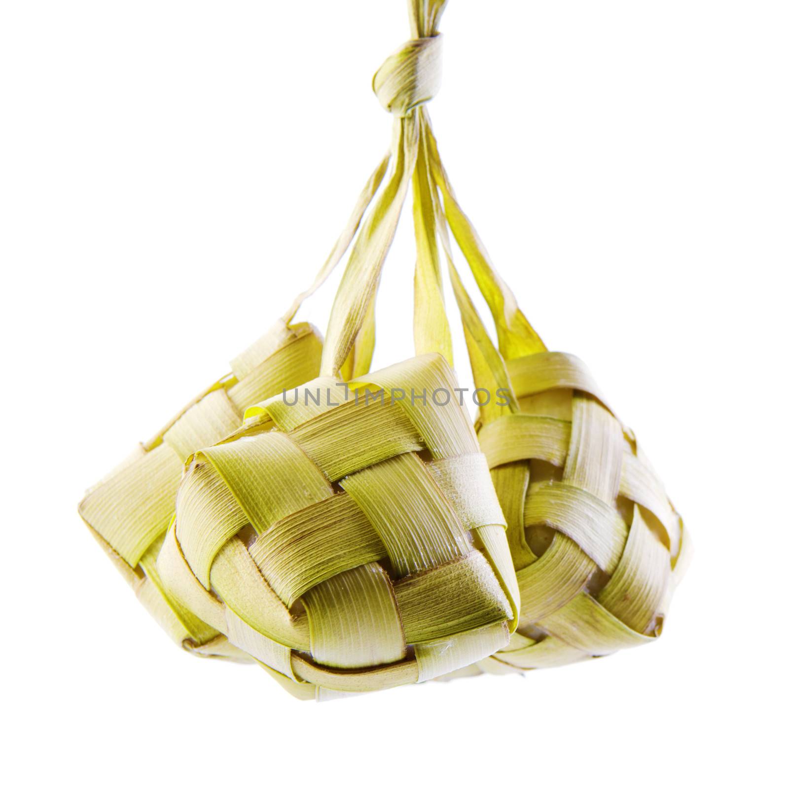 Ketupat or packed rice dumpling. Traditional Malay ramadan food. Popular Malaysian food isolated on white background.