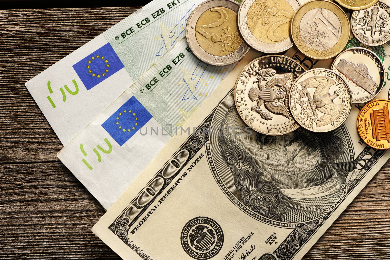 US and euro currency over wooden background
